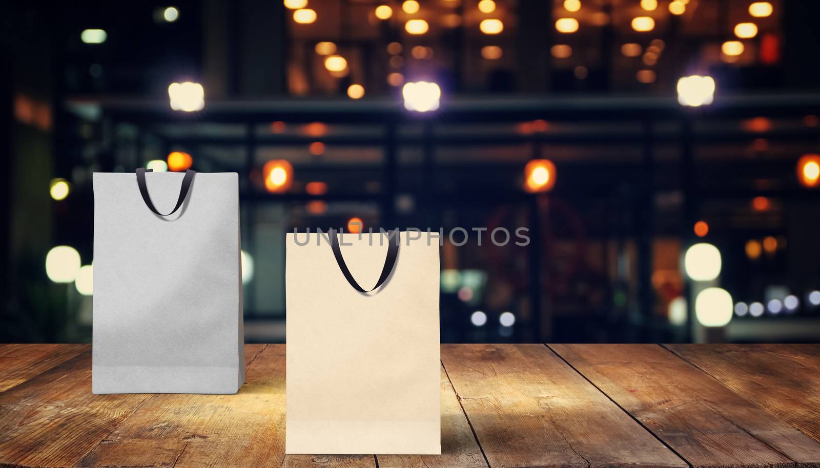 Two paper bags for shopping on a wooden background