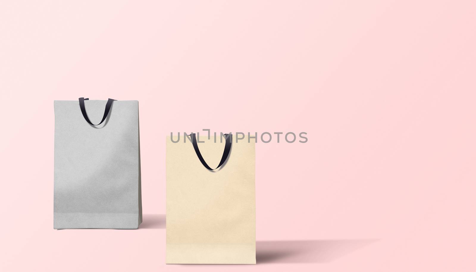 Two paper bags for shopping on a pink background by boys1983@mail.ru
