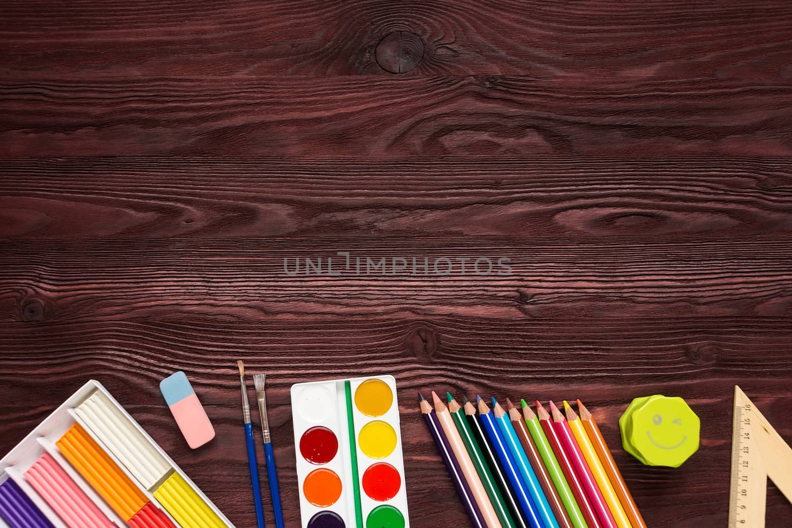 School supplies on a red background, paints and brushes