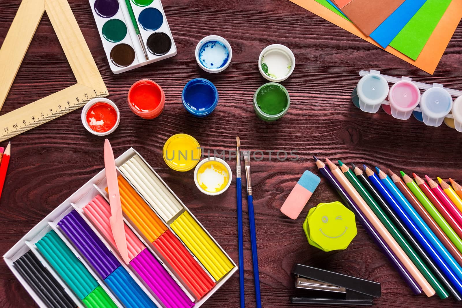 School supplies on a red background, paints and brushes