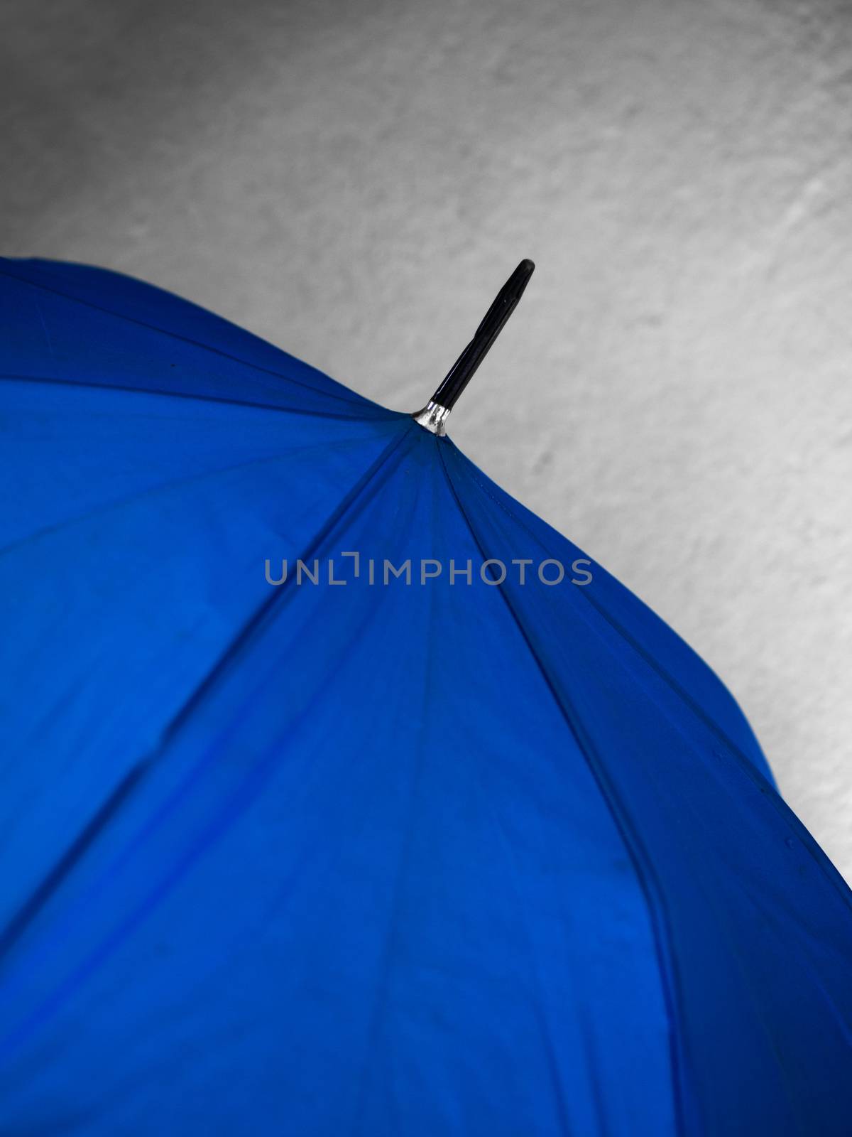 COLOR PHOTO OF CLOSE-UP OF BLUE COLOR UMBRELLA