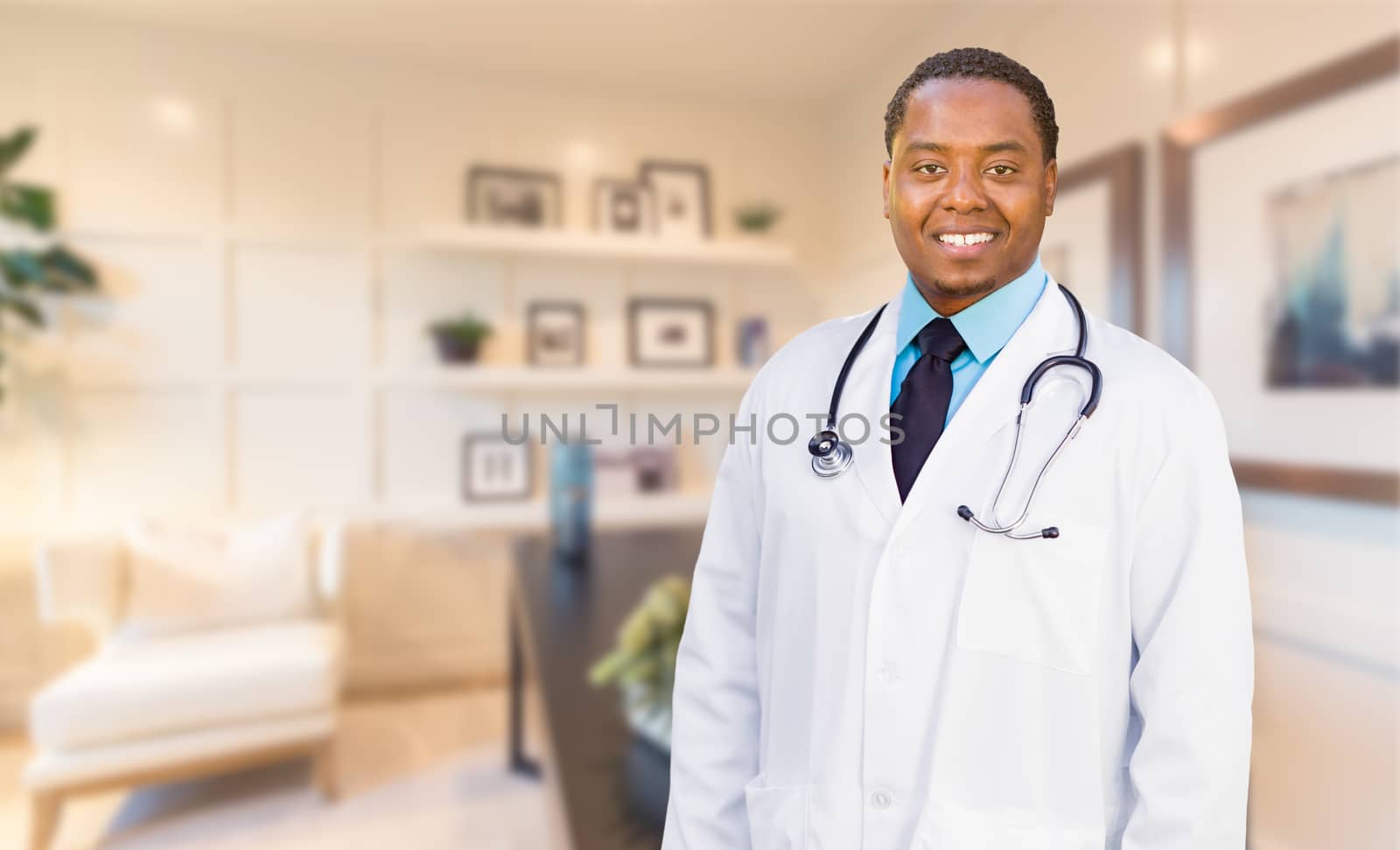 Young African American Doctor or Nurse Standing in His Office.
