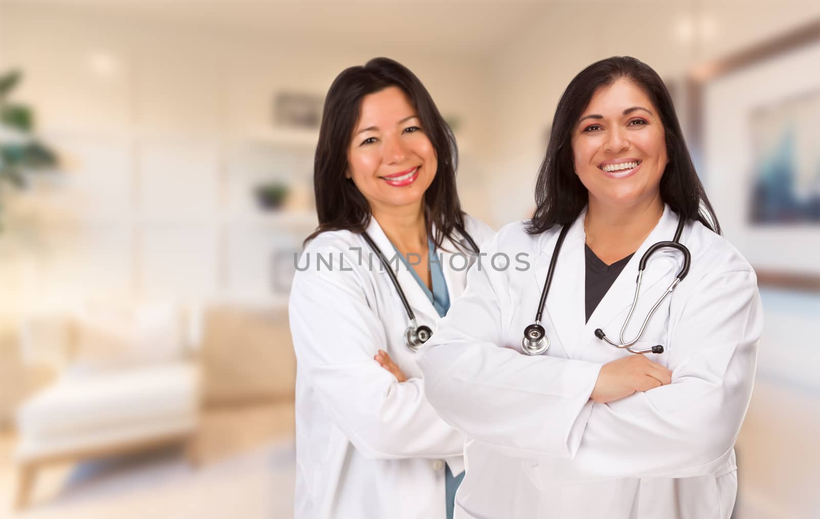 Female Hispanic Doctors or Nurses Standing in an Office.