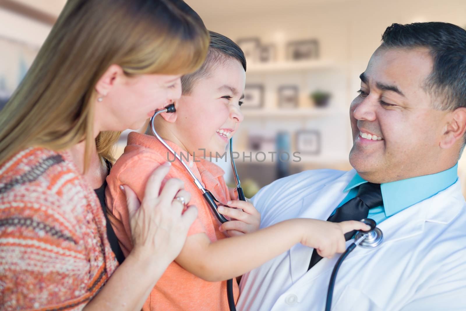 Young Boy and Mother Visiting with Hispanic Doctor in Office by Feverpitched