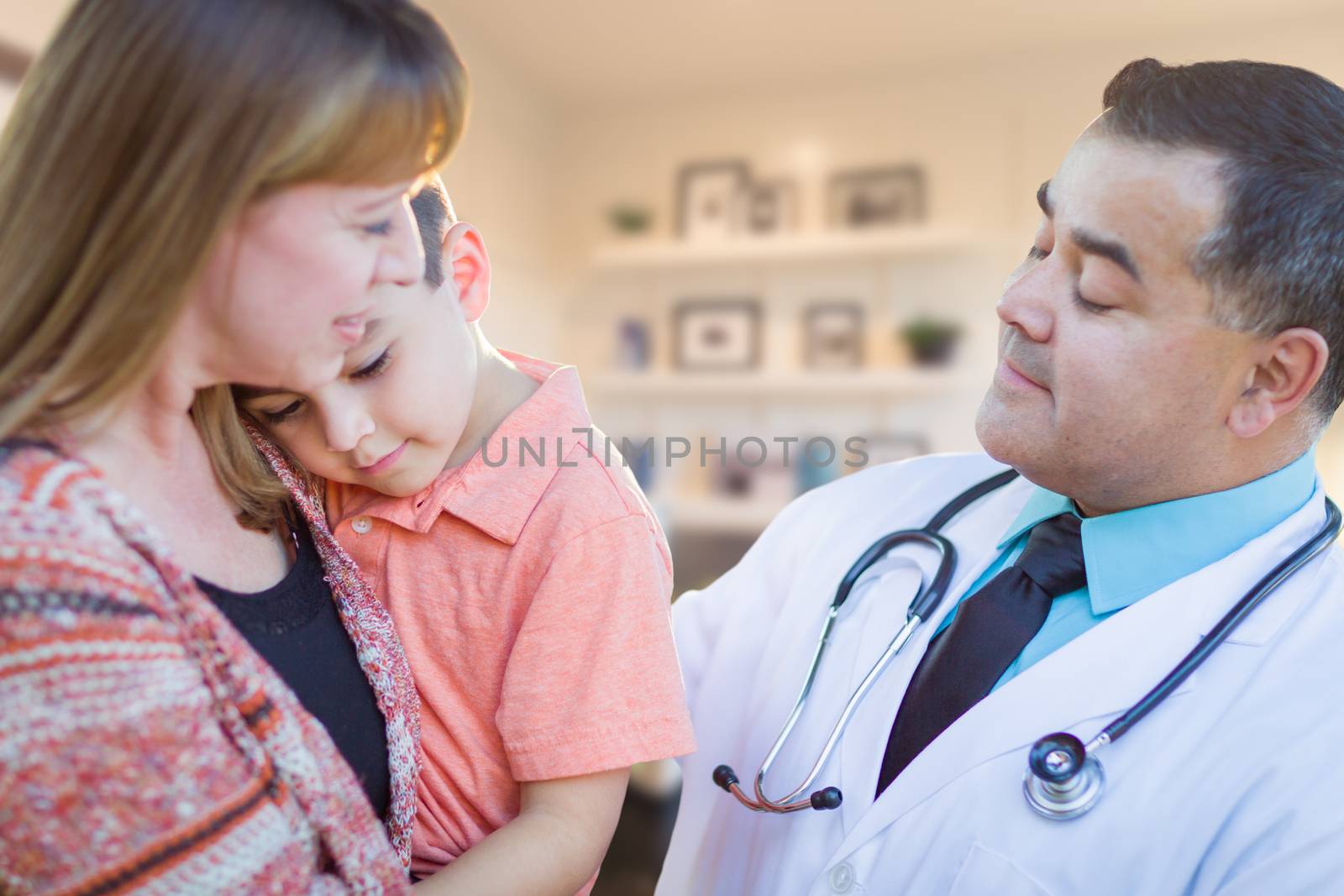 Young Sick Boy and Mother Visiting with Hispanic Doctor in Office. by Feverpitched