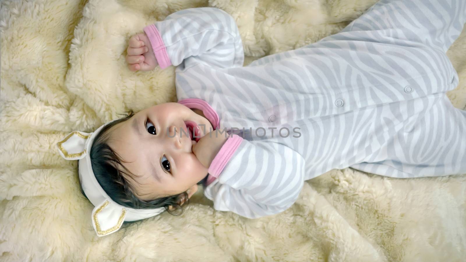 Asian cute baby girl lying on the bed
