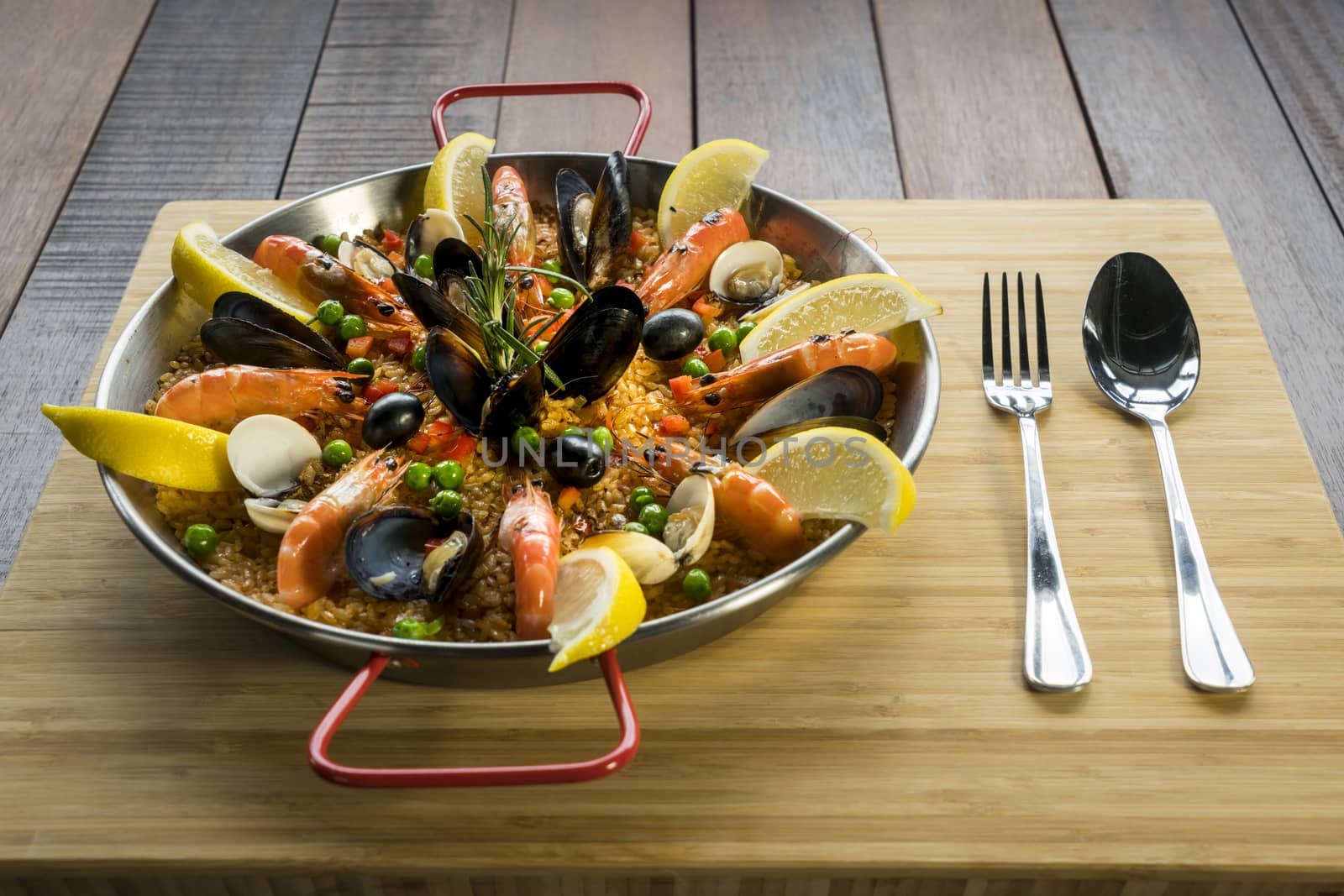 Paella with seafood vegetables and saffron served in the traditional pan