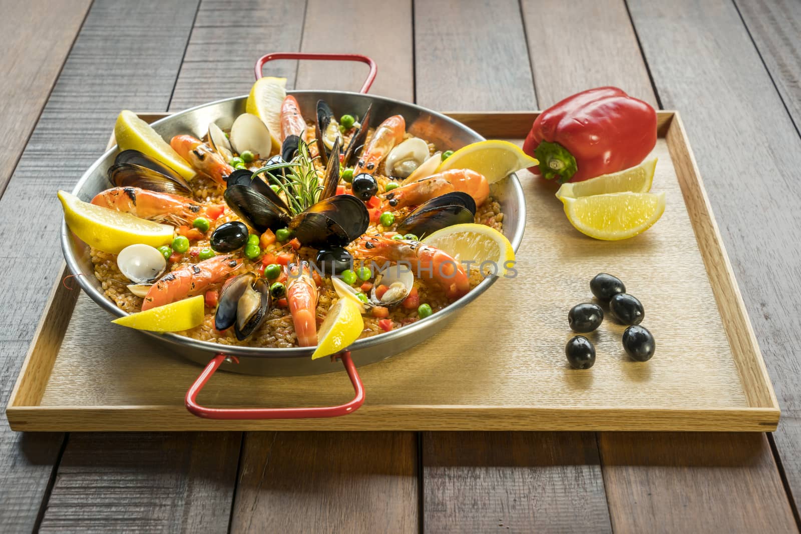 Paella with seafood vegetables and saffron served in the traditional pan