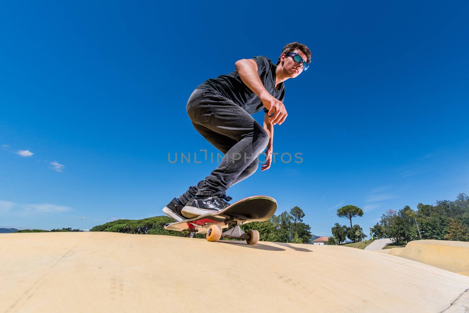 Skateboarder on a pump track park by homydesign