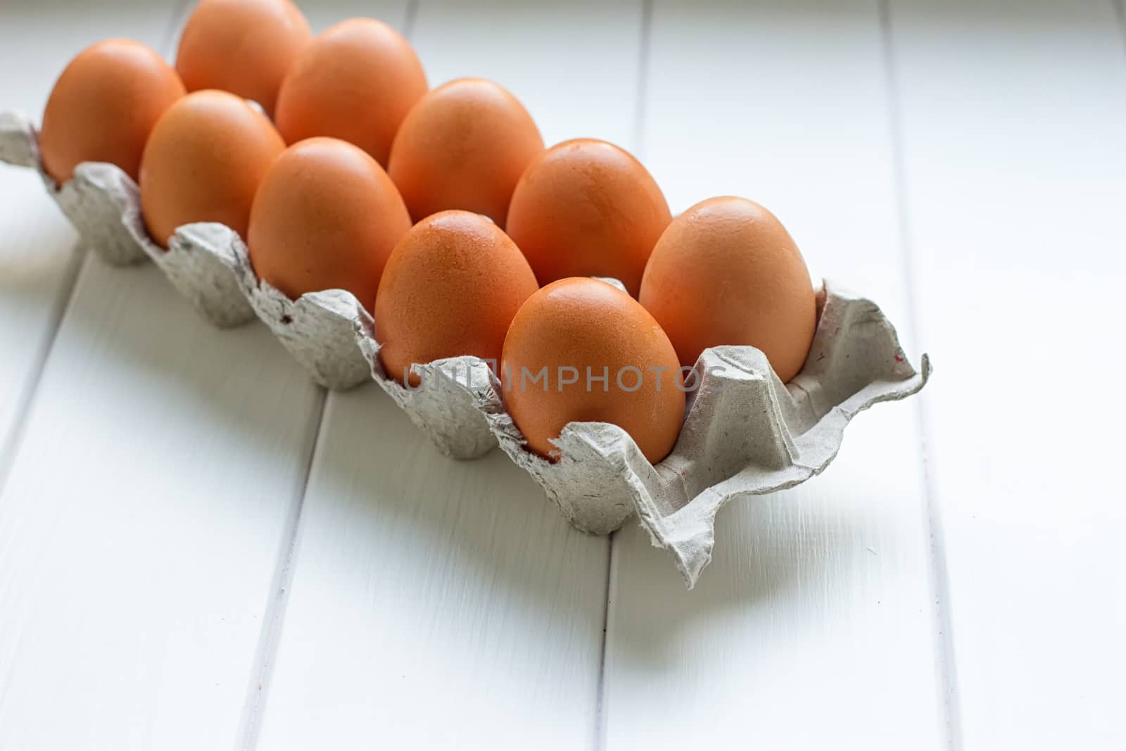 Eggs in the paper tray package on white background.