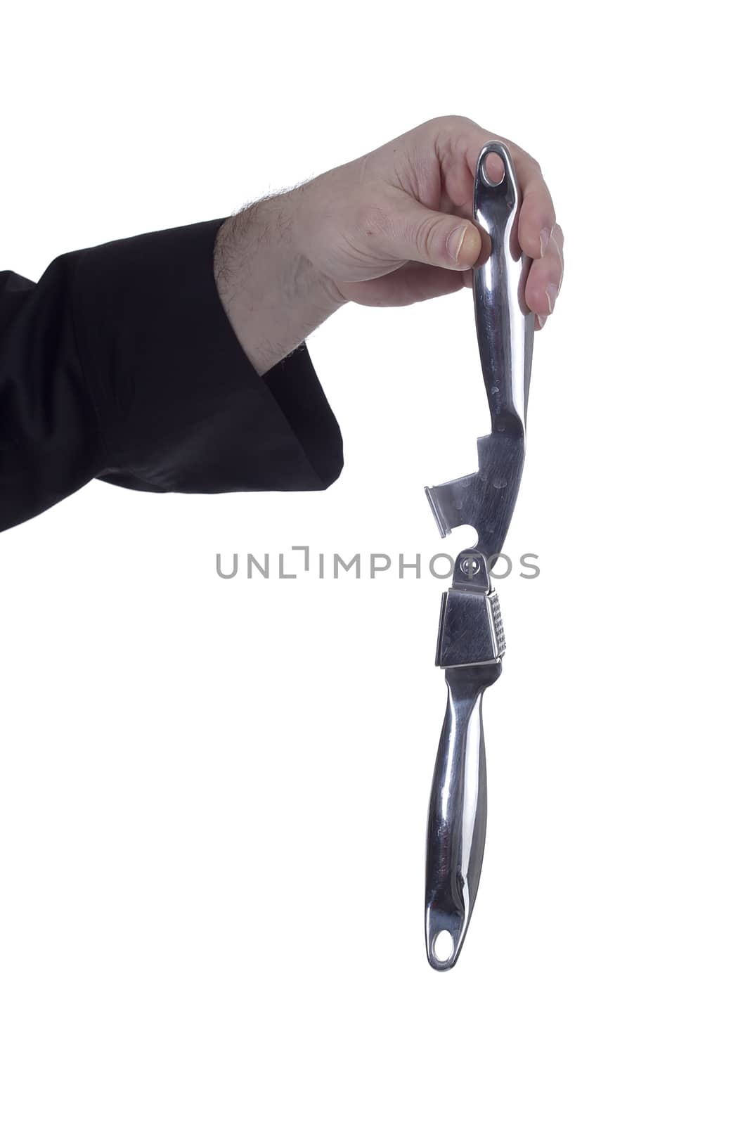 Garlic crusher in a hand on a white background
