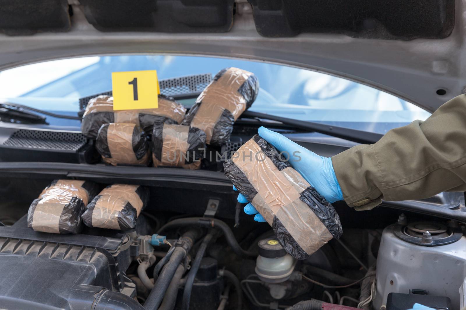 Drug smuggling in a car engine compartment by wellphoto