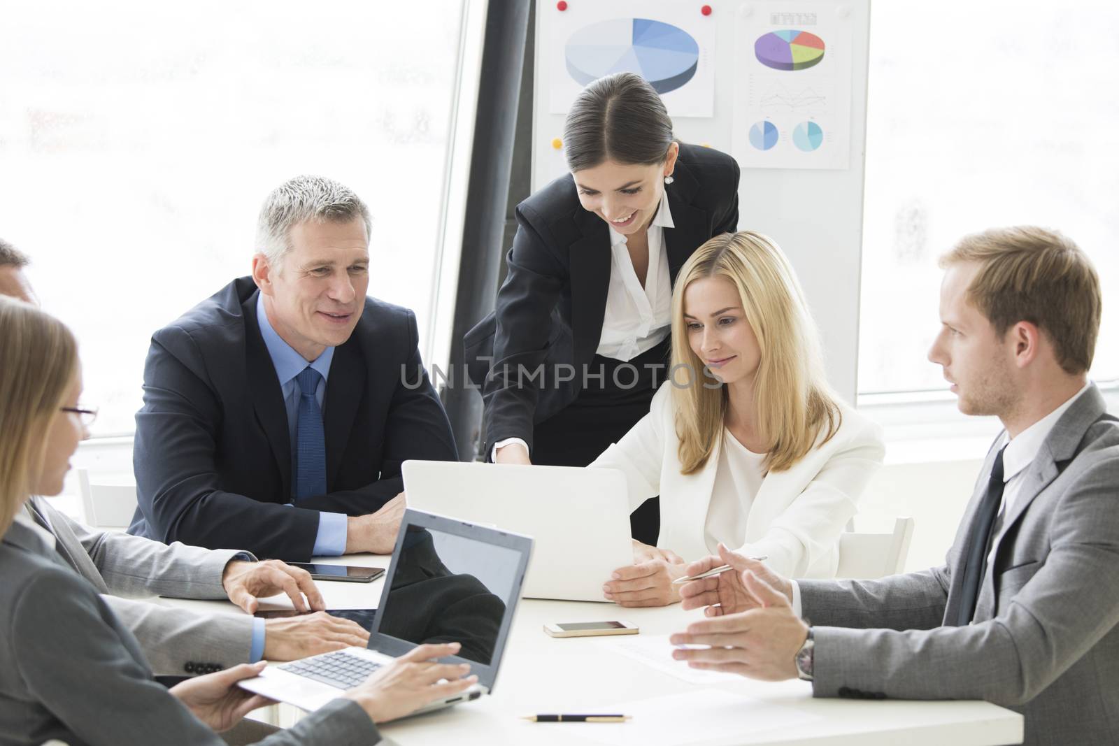 Meeting of business partners using laptops and talking at the table