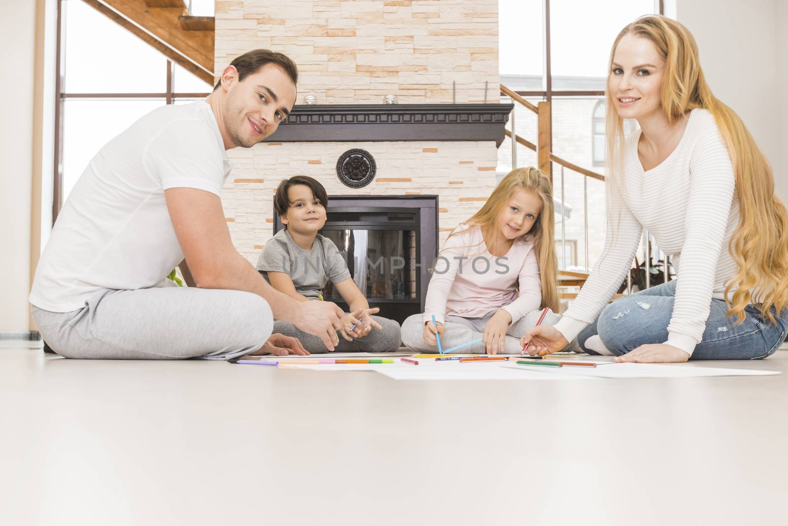 Family drawing together in a living room by Yellowj