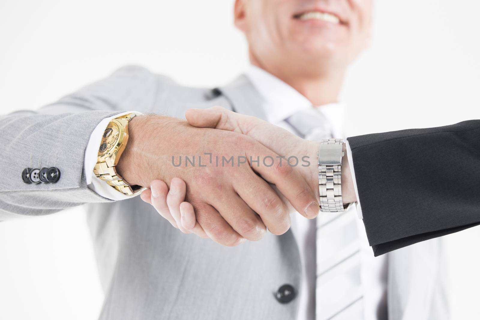 Confident business men shaking hands with each other. Close-up view of the hands of a businessman in formal wear