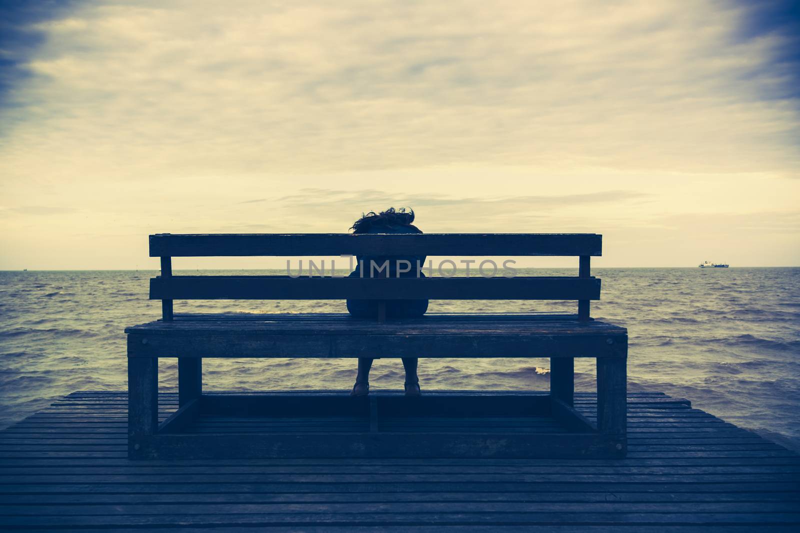 Women sits on a wooden chair  by ahimaone