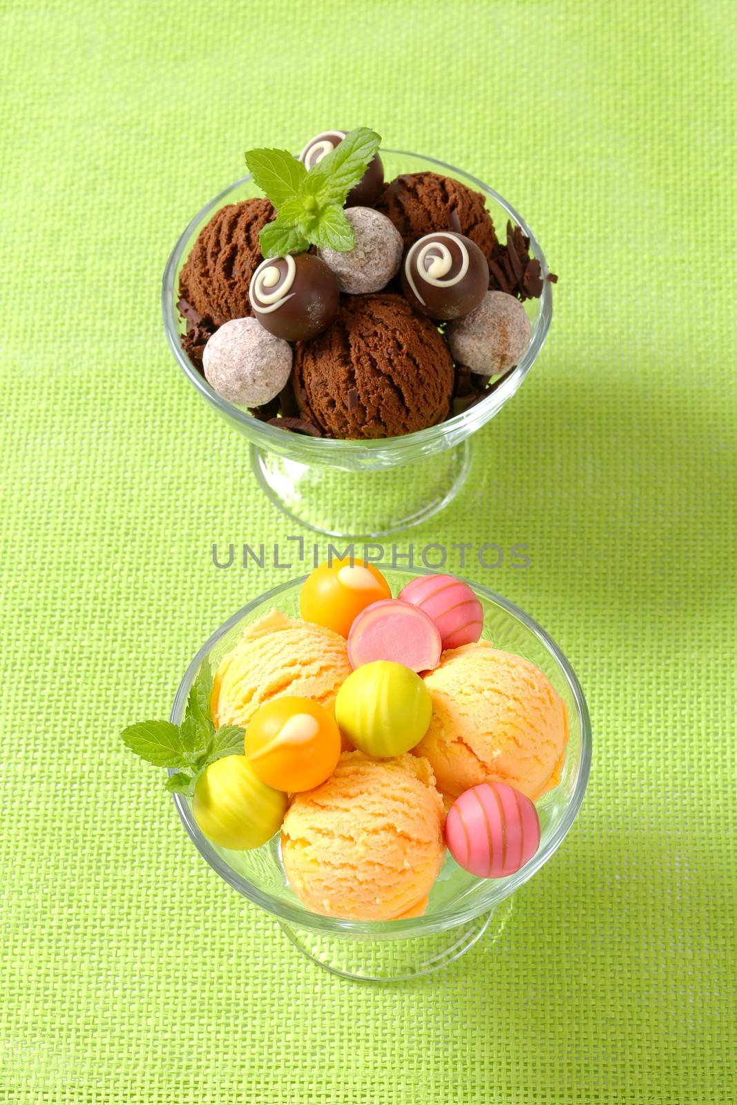 Two cups  of ice cream  with chocolate truffles and fruit-flavored pralines