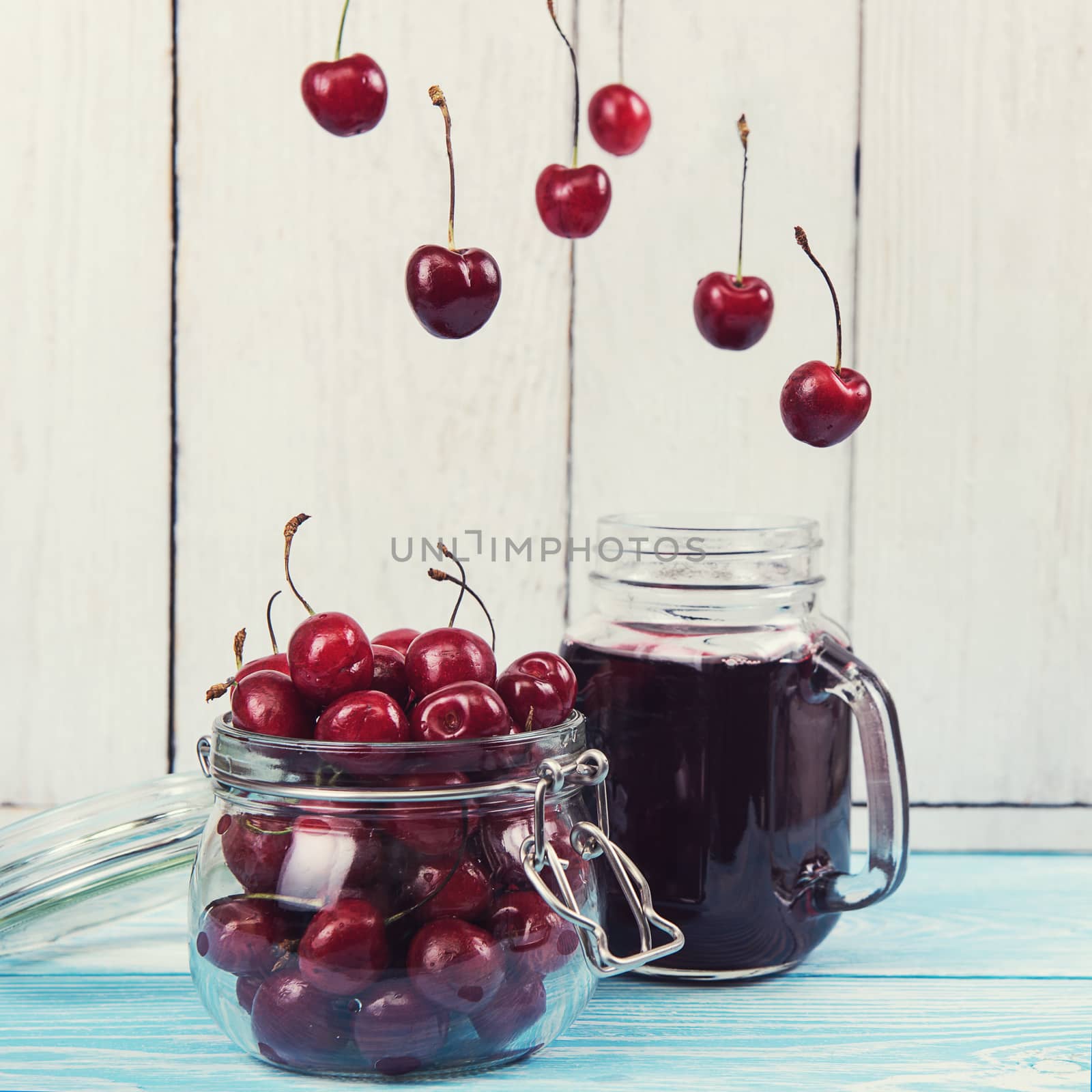 Cherry juice with glass of berries by rusak