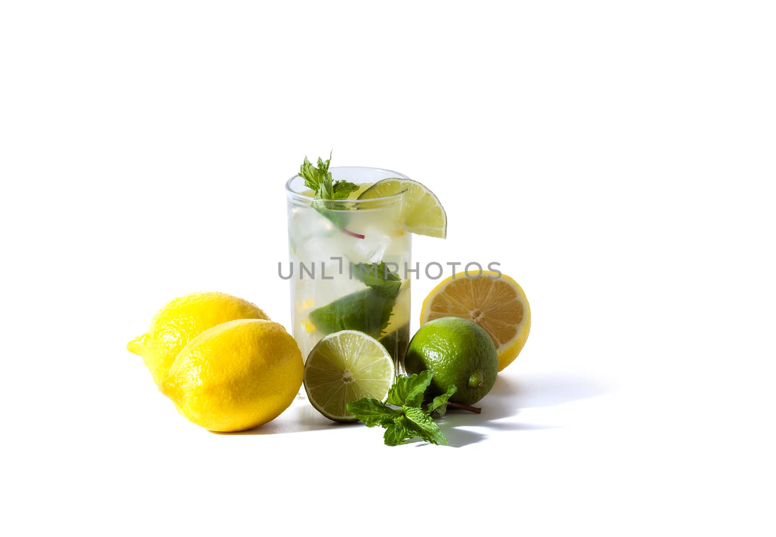 A glass of lemonade with lemon slices, lime, mint and ice