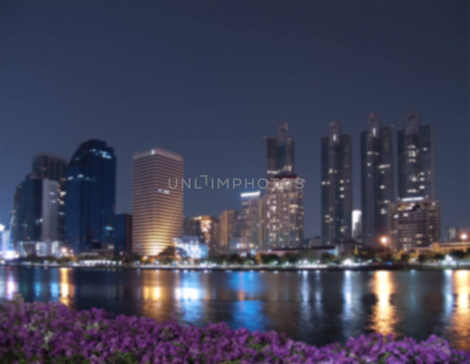 Blurred cityscape with high-rise building at night scene, Bangkok, Thailand