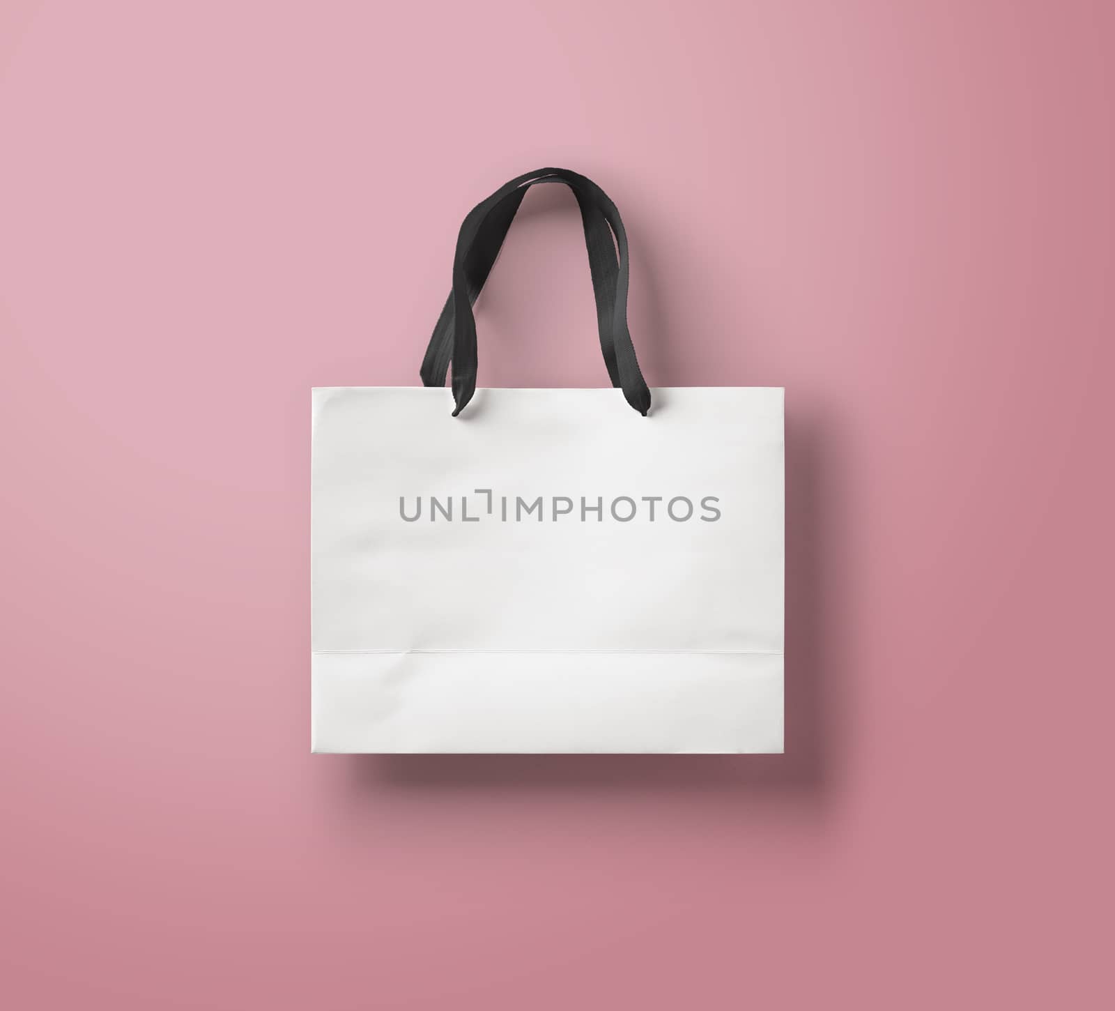 paper bag for shopping on a pink background
