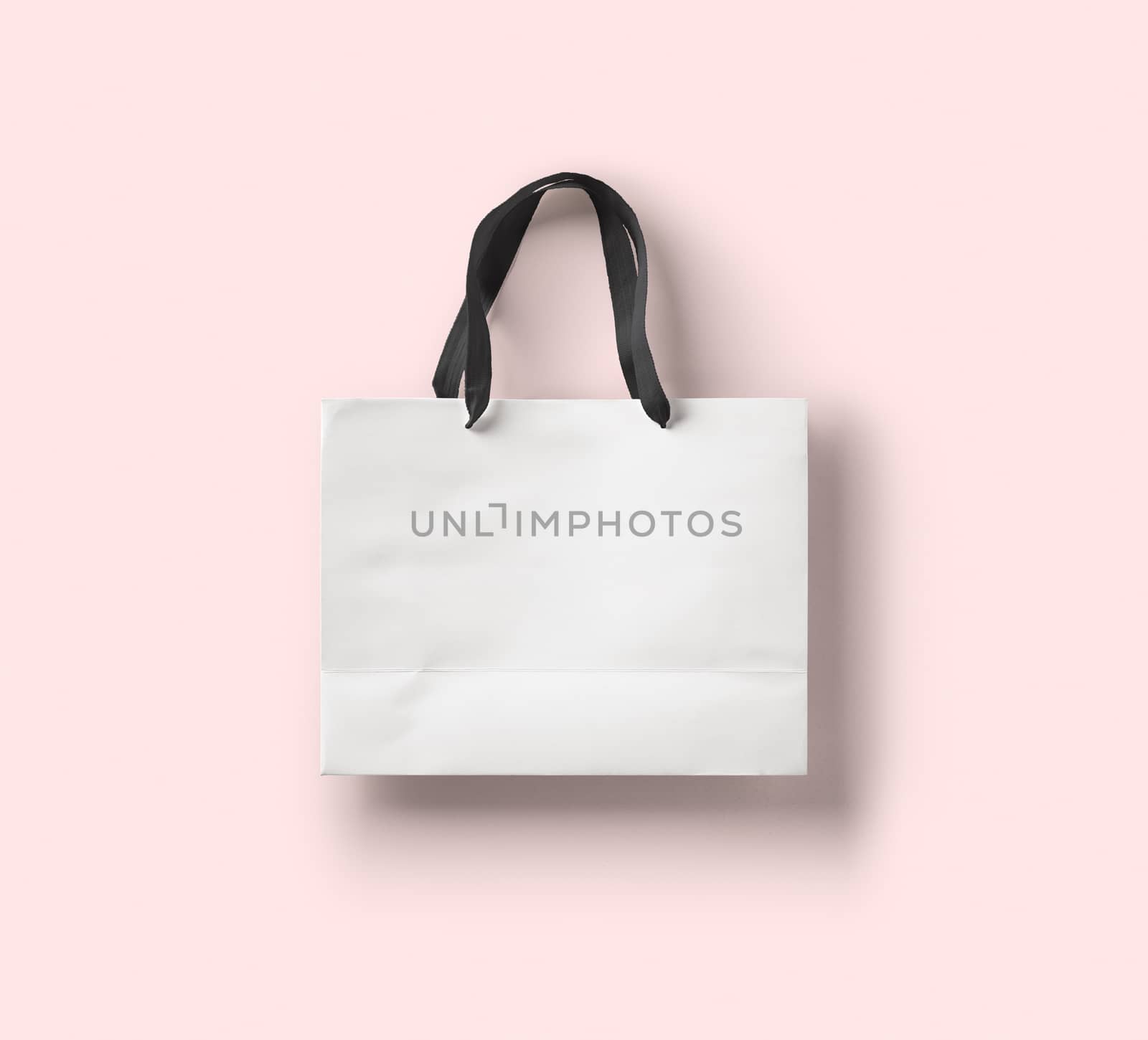 paper bag for shopping on a pink background