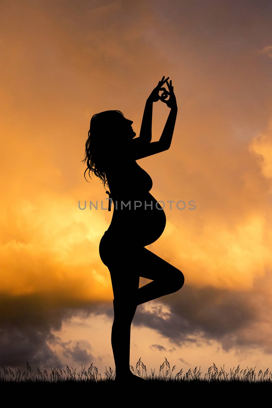 a pregnant girl doing yoga at sunset by adrenalina