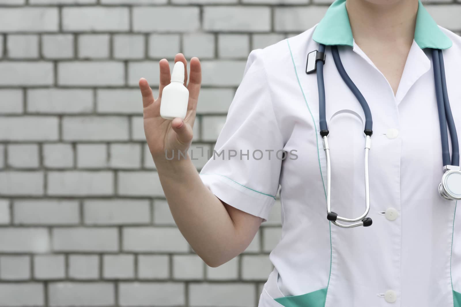 Medicine concept doctor. On a white brick wall background. Keeps the medication empty white. Advertising products. Photo for your design