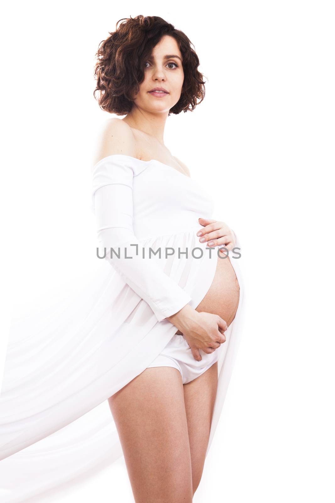 Pregnant woman in white dress on white background.