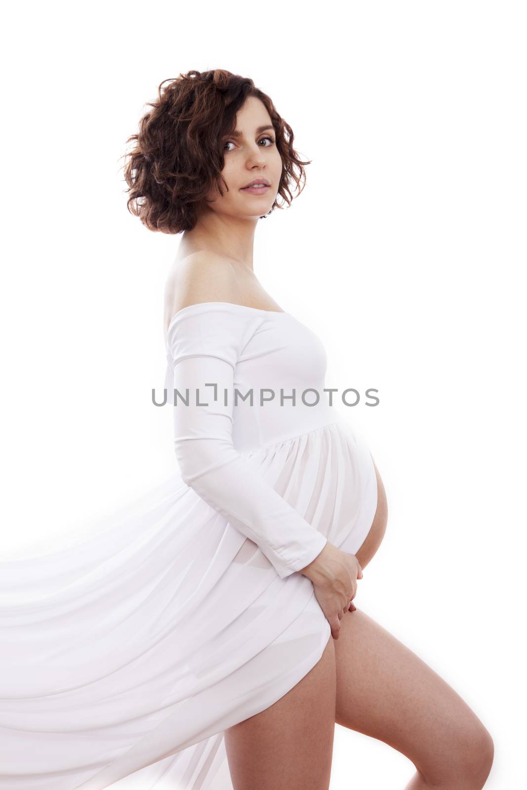 Pregnant woman in white dress on white background.