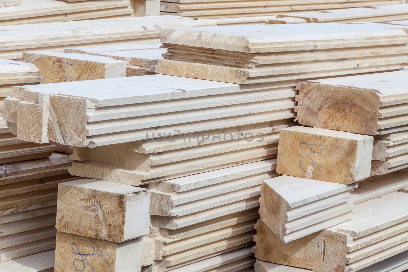 Wooden logs material for new house - construction site.