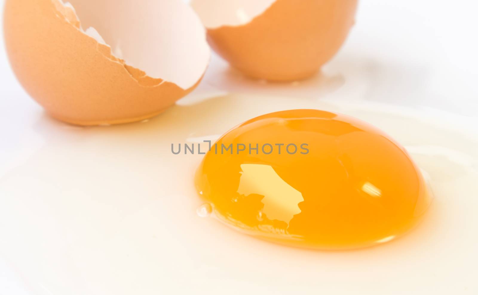 Closeup broken egg on white background