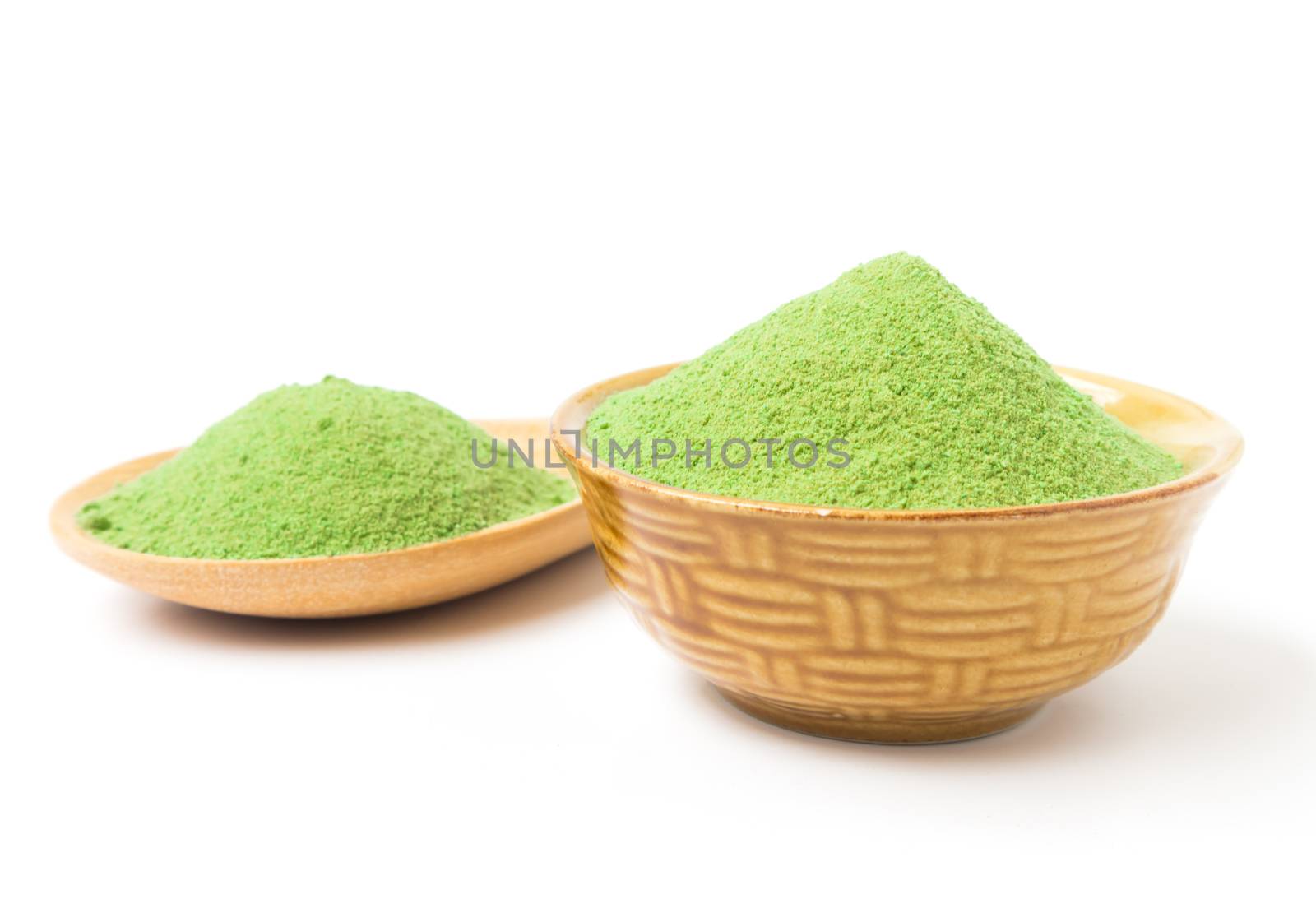 Green matcha tea powder in bowl white background