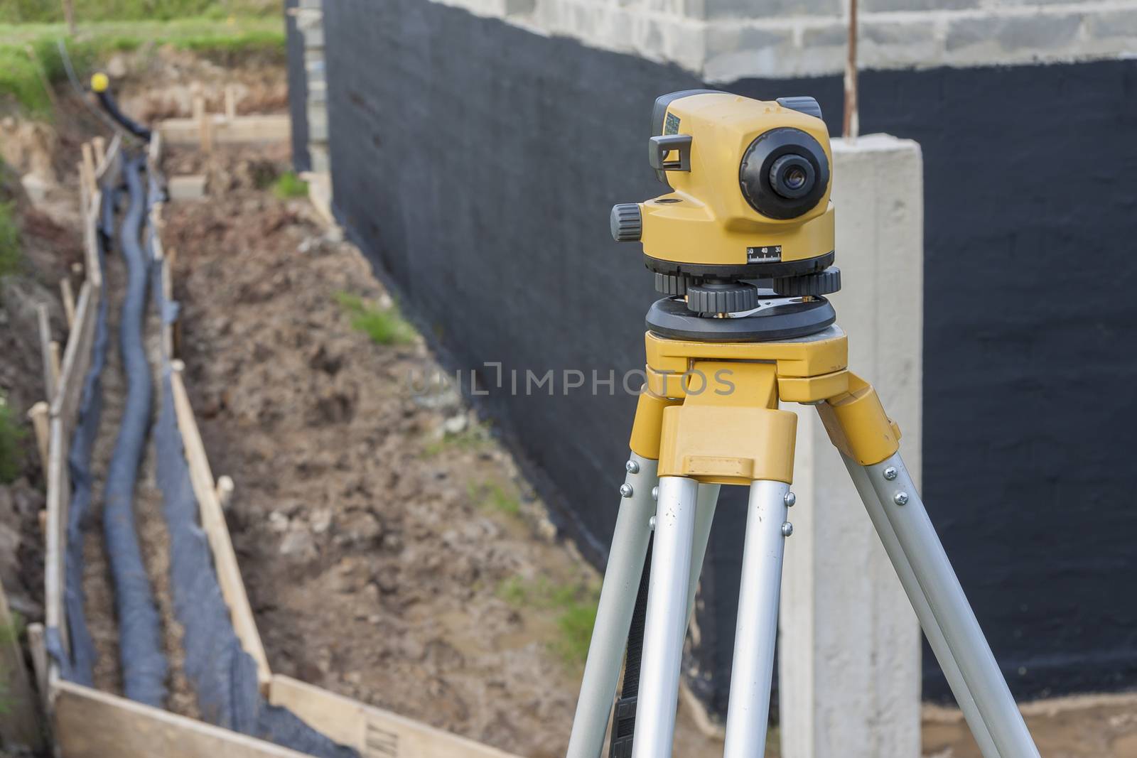Surveyor equipment optical level at construction site by parys