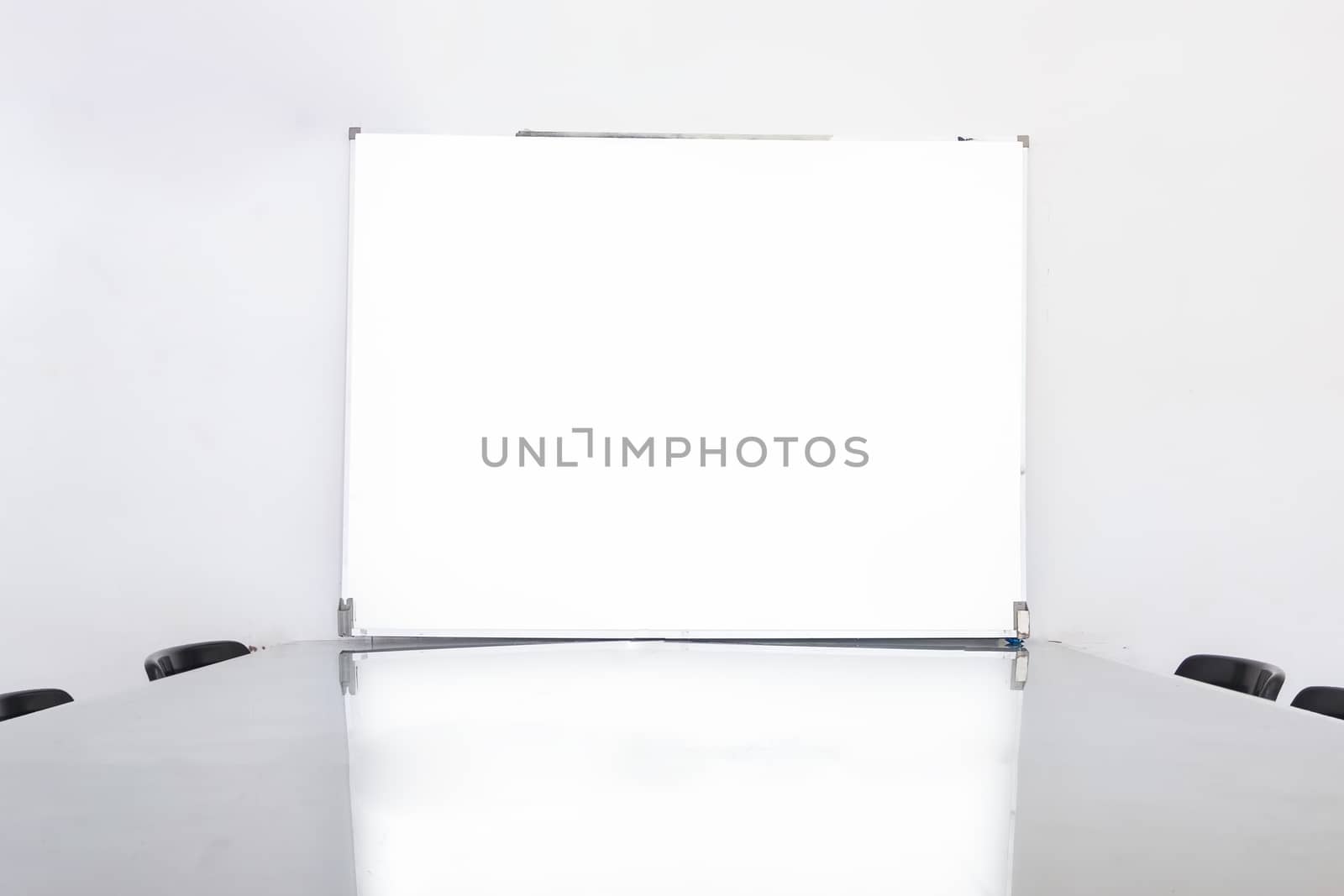 Closeup and soft focus of white empty board in conference room.