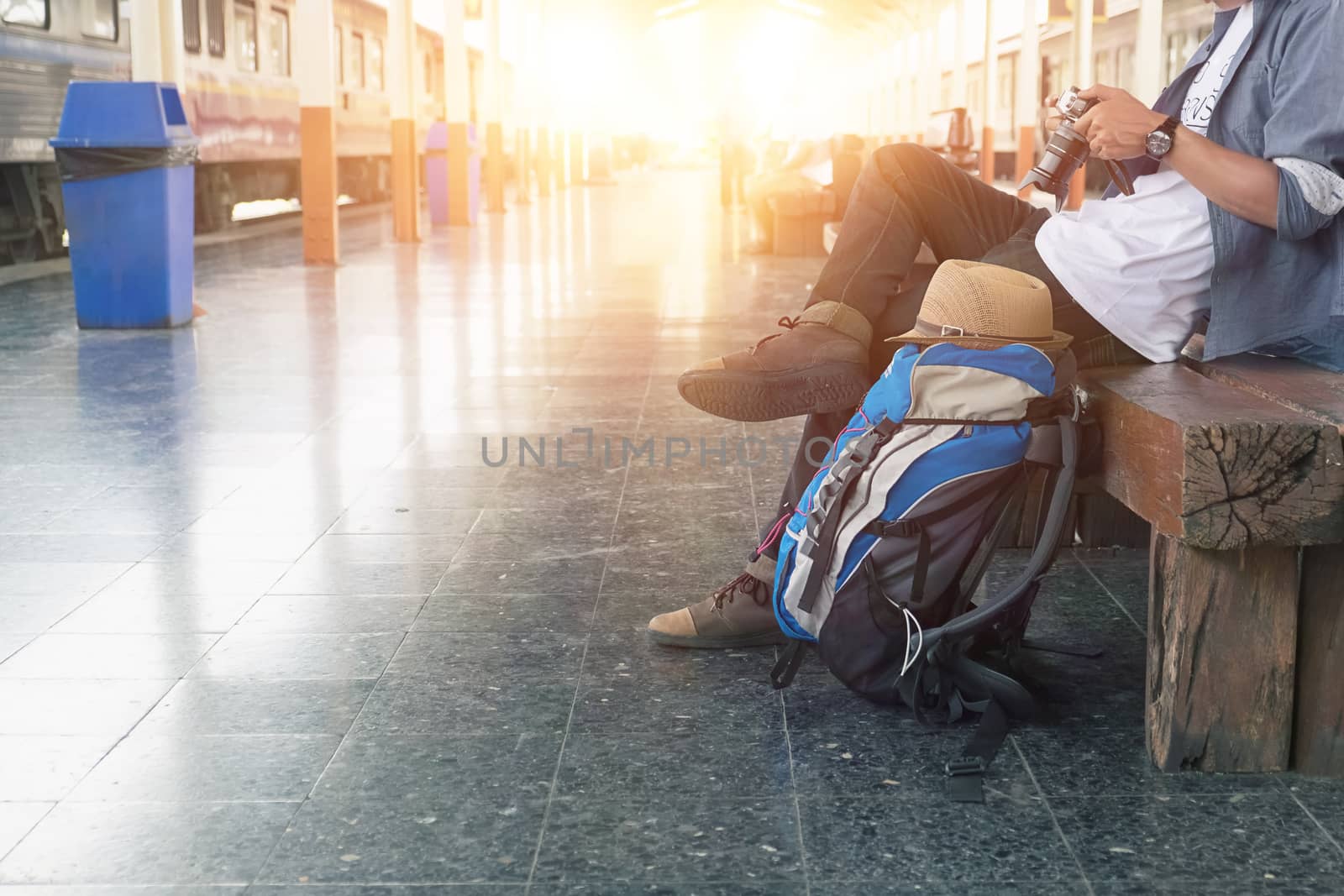 Backpacker at the train station with a traveler. Travel concept.
