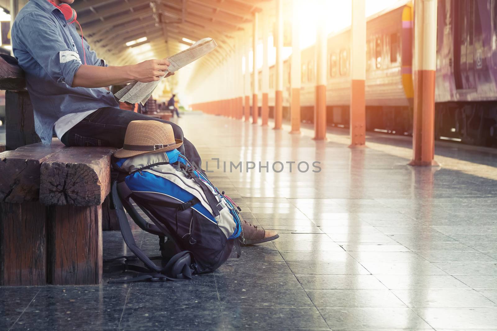 Backpacker at the train station with a traveler. Travel concept.