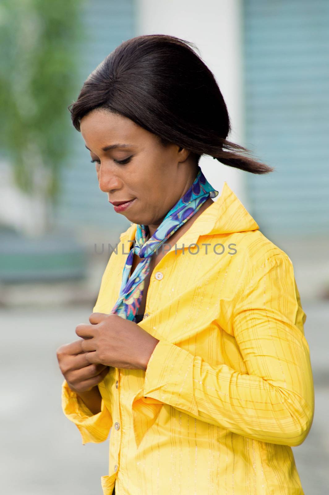 young woman ties a scarf on neck like a escapes.