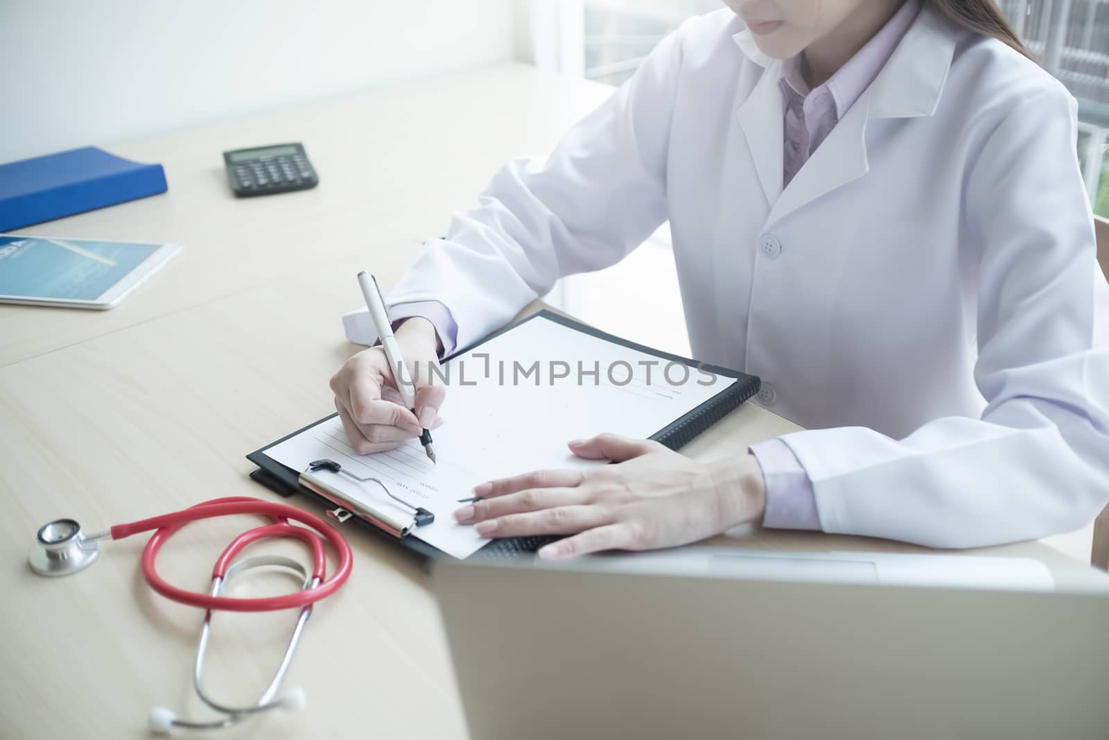 Medicine doctor hand writing something on medical from. Medical  by prathanchorruangsak