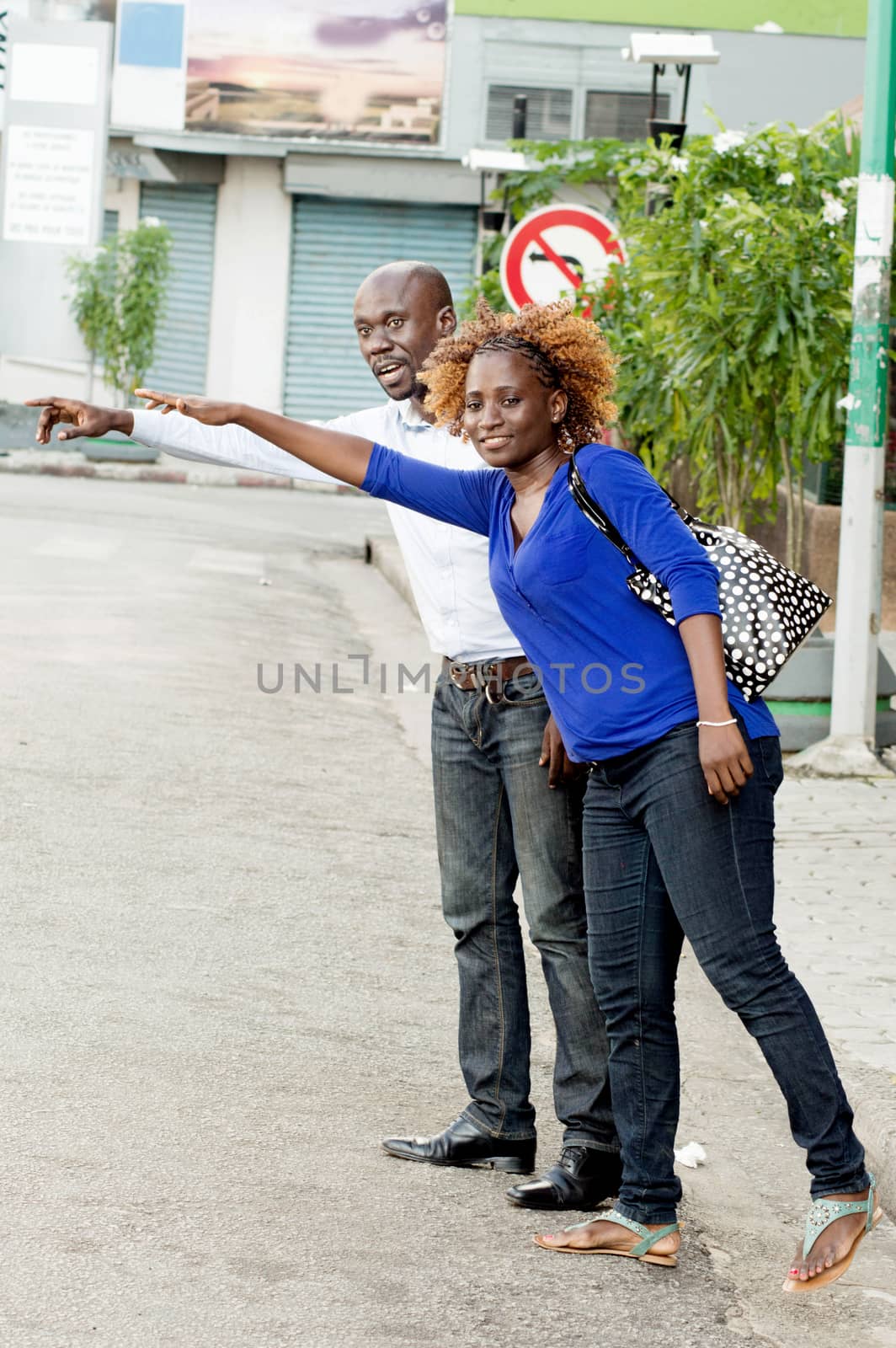 young couple from a stroll, stop a car to take them to their home.