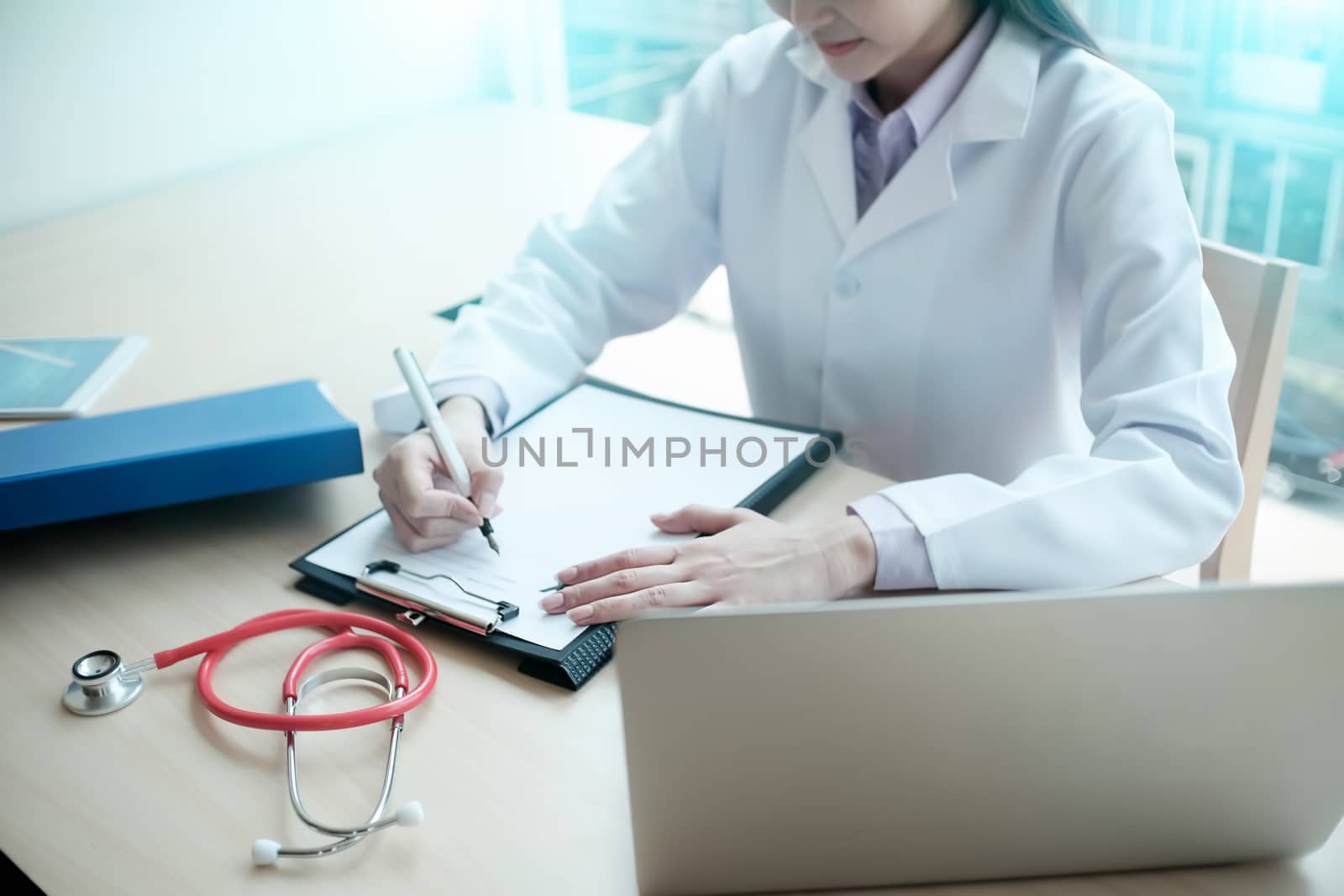 Doctor is consulting the patient and lighting on window. by prathanchorruangsak