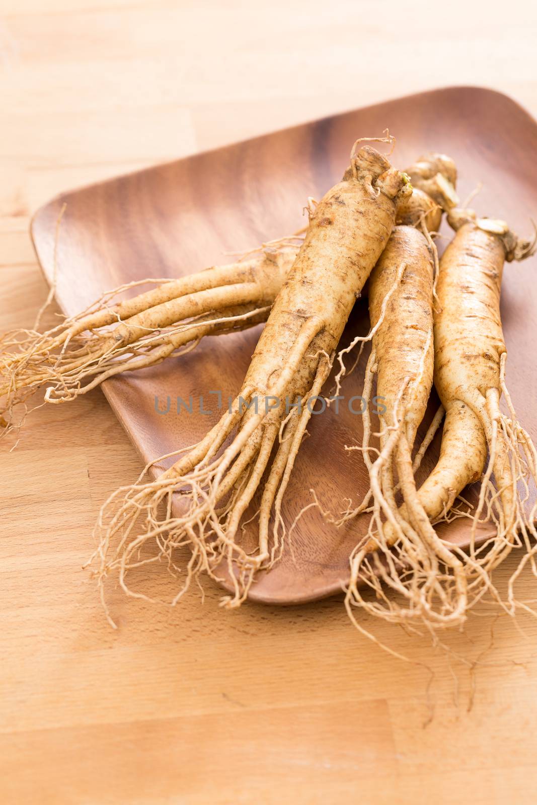 Ginseng over wooden background by leungchopan