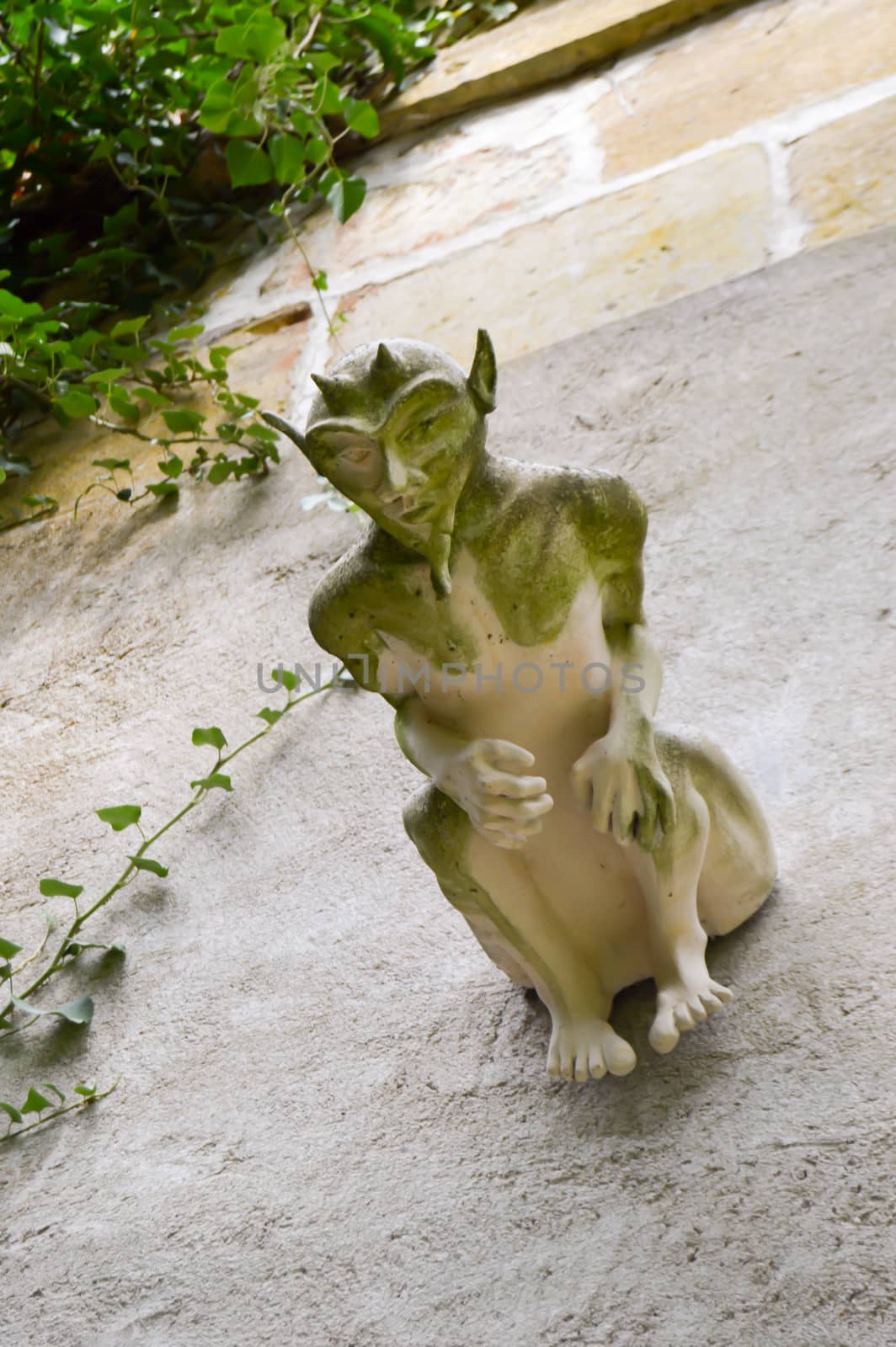 Gargoyle with horns and large ears on a wall in the town of Bar le Duc in the department of the Meuse in France