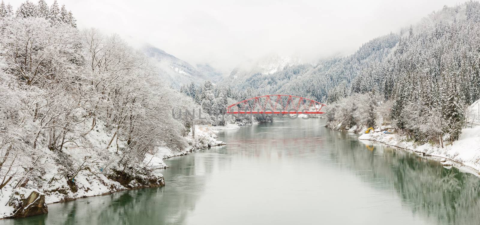 winter landscape with Red Bridge along Tadami River in Fukushima Japan Panorama 