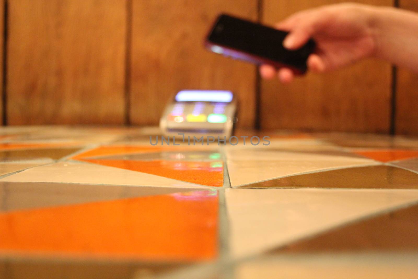 contactless payment phone pdq with hand holding credit card to pay by cheekylorns