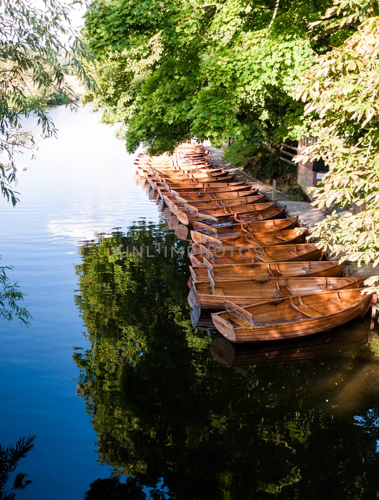 a group of parked wooden row boats from above in dedham on the river stour; UK