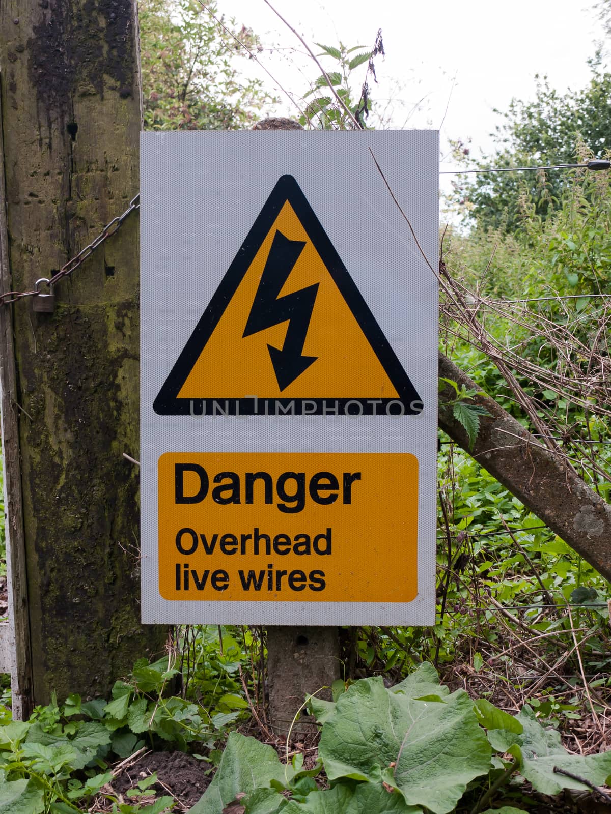 warning yellow triangle sign danger overhead live wires; UK