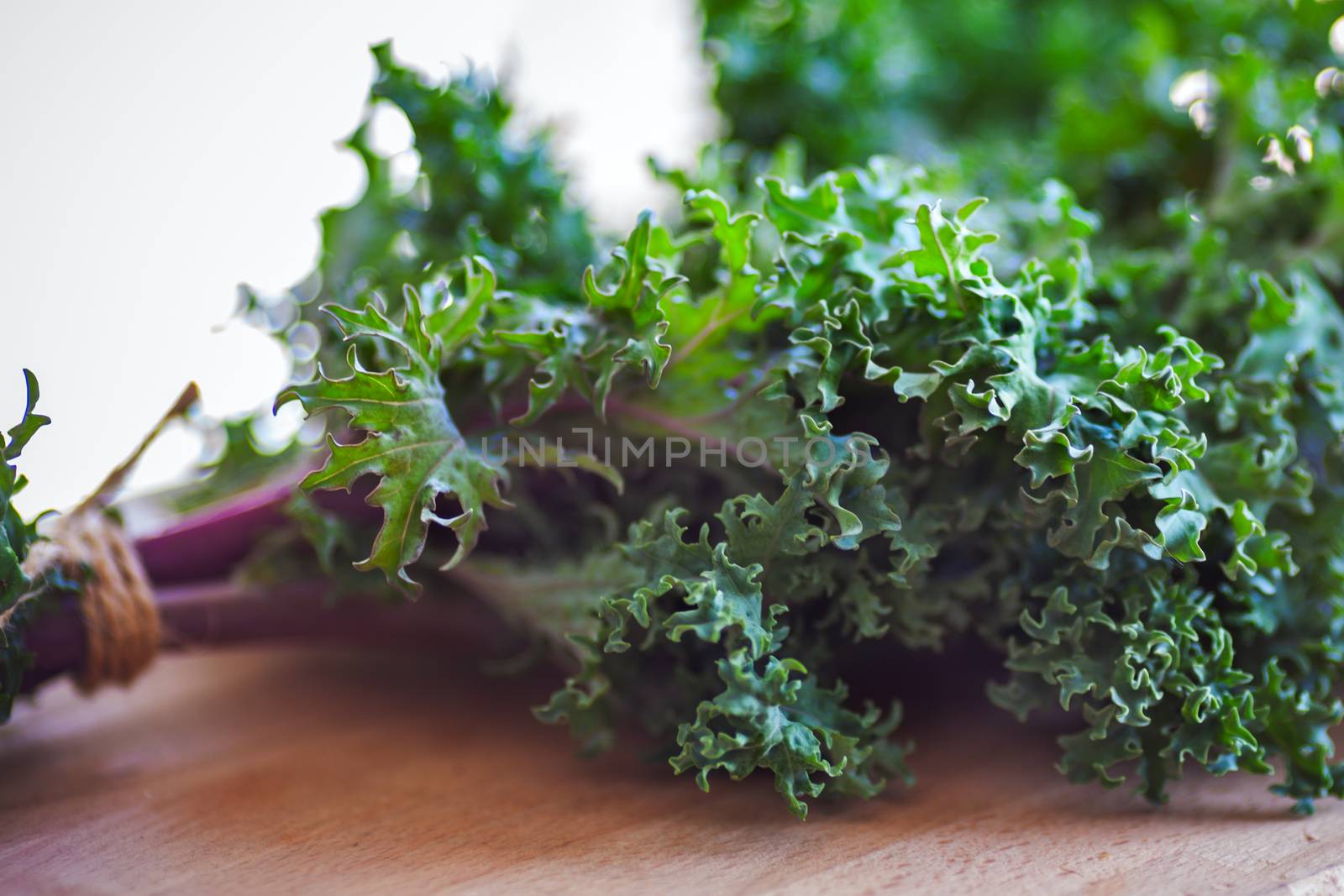 A bunch of fresh Kale salad on a wooden table