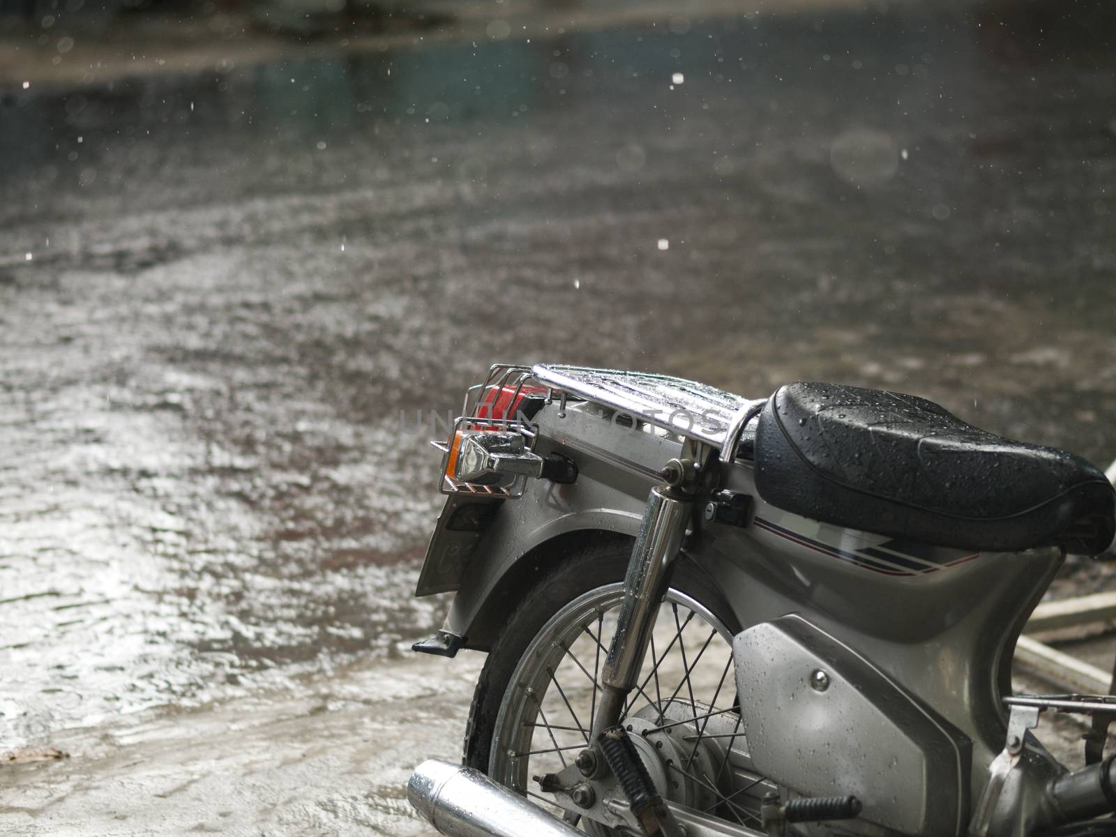 COLOR PHOTO OF MOTORCYCLE AND CLOSE-UP OF RAINDROPS
