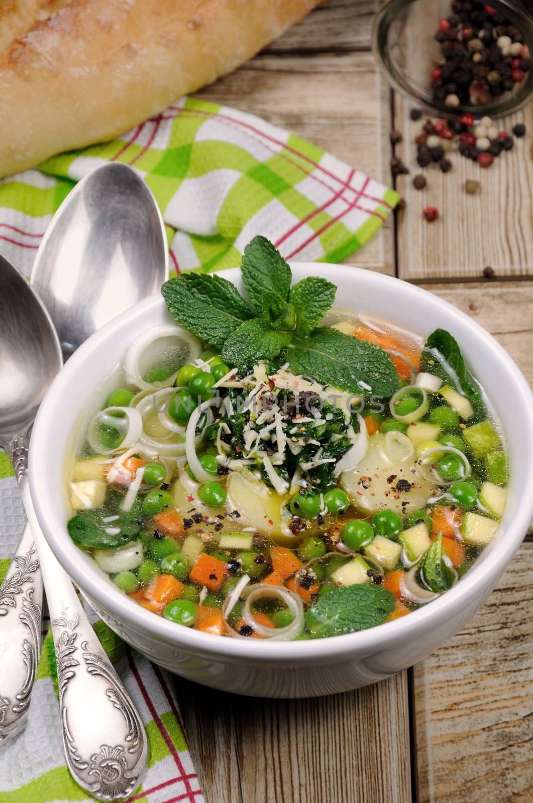 Light, refreshing soup of carrots, zucchini, potatoes, leeks, peas, pesto, parmesan and mint leaves.
